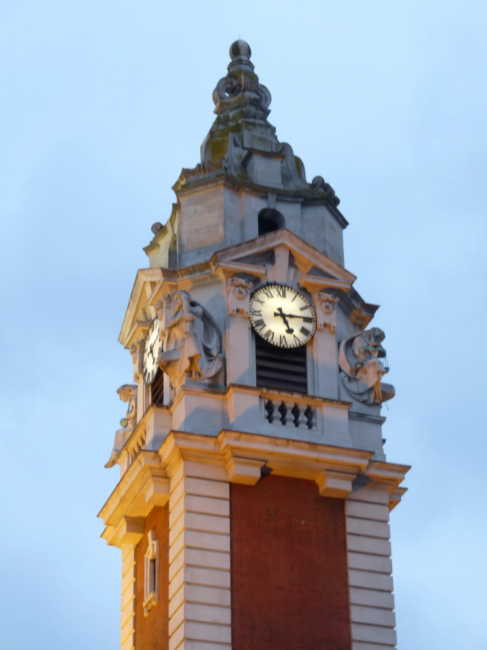 The clock tower of Lambeth Town Hall in Brixton, seen against a clear sky.