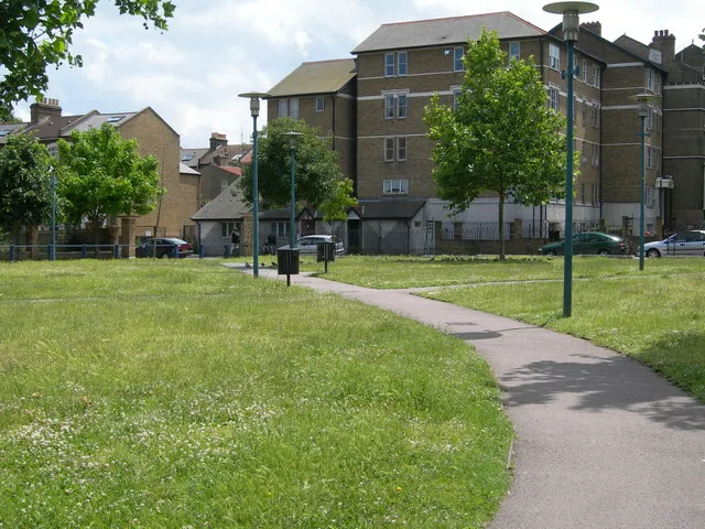 Windrush Square in Brixton, with paving, trees and passers by.